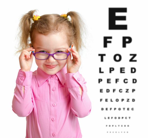 Child wearing spectacles in front of reading chart